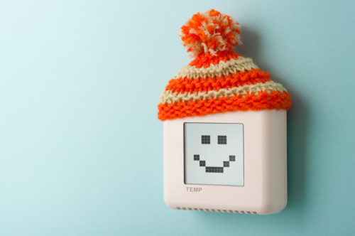 Digital thermostat with smile and woolly hat