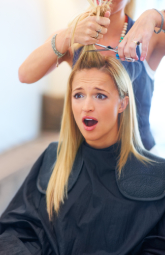 Shocked young woman having a bad haircut at the salon