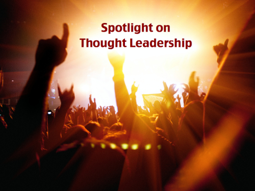Rock concert crowd facing a spotlight with the text "Spotlight on Thought Leadership"